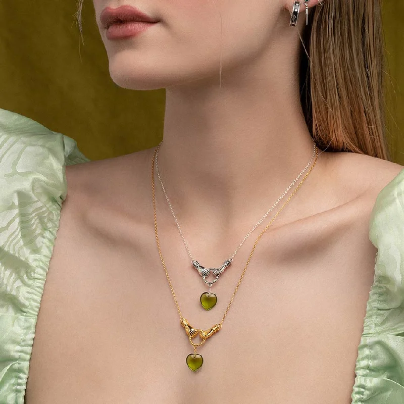 Spire gem necklace-UNITE. Hand Grasping Green Glass Heart Necklace - Gold